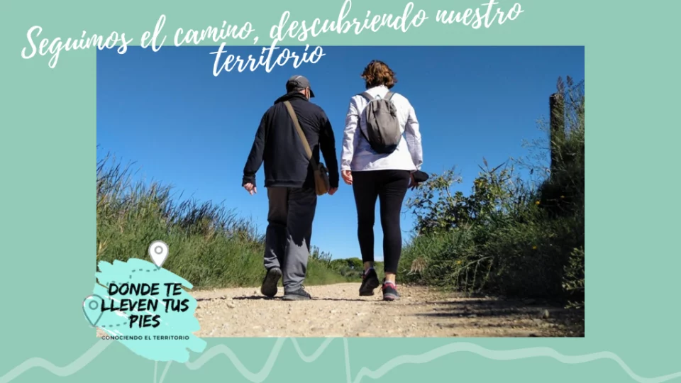 imagen de dos personas caminando por un sendero